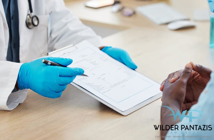 Doctor with a pen and paper pointing out content to another person