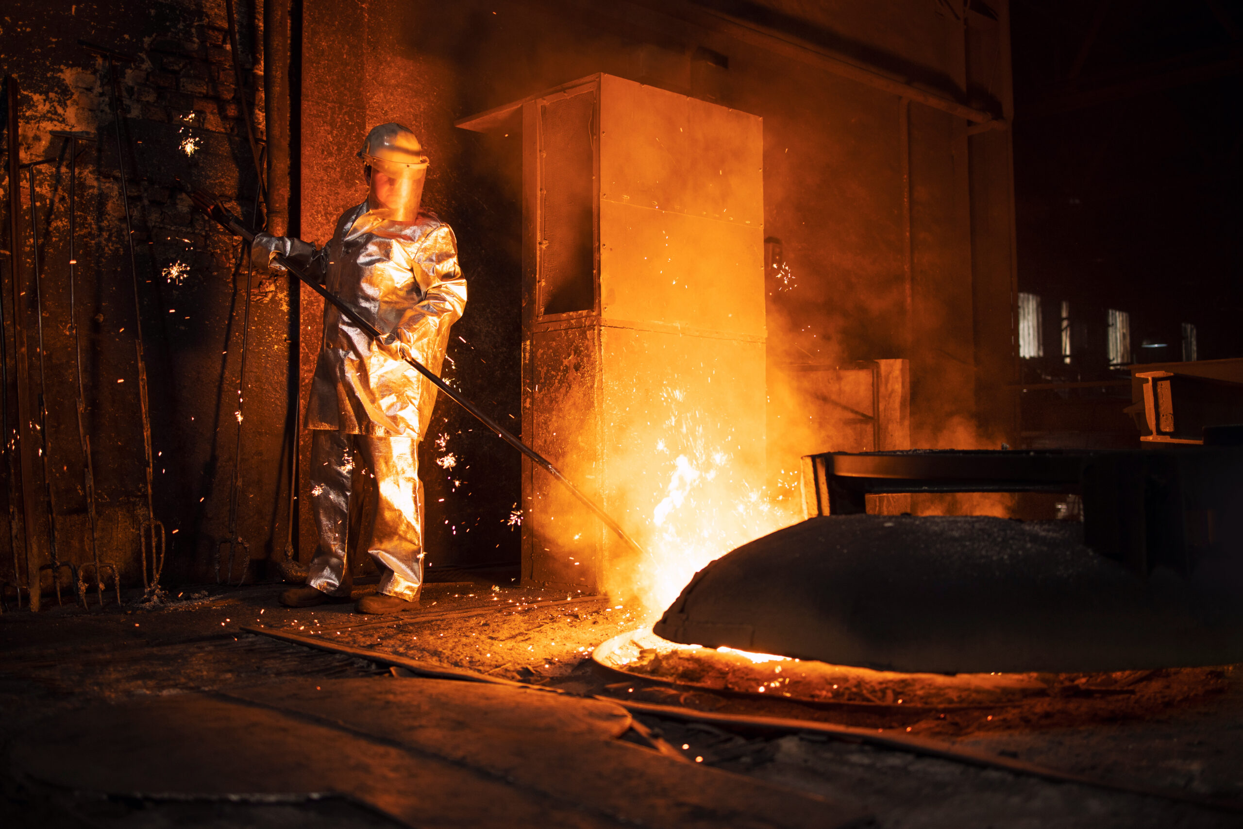 Foundry,Worker,In,Aluminized,Protective,Fire,Suit,Checking,Temperature,Of
