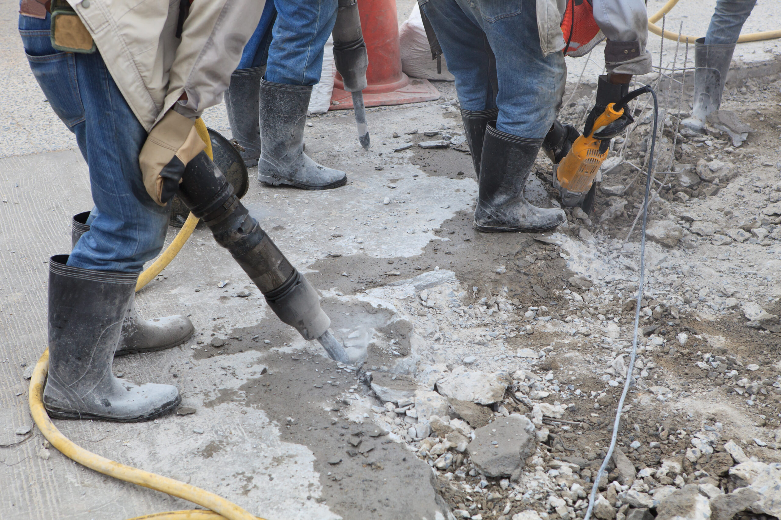 Worker,Of,Road,Construction,Drilling,Cement,Ground