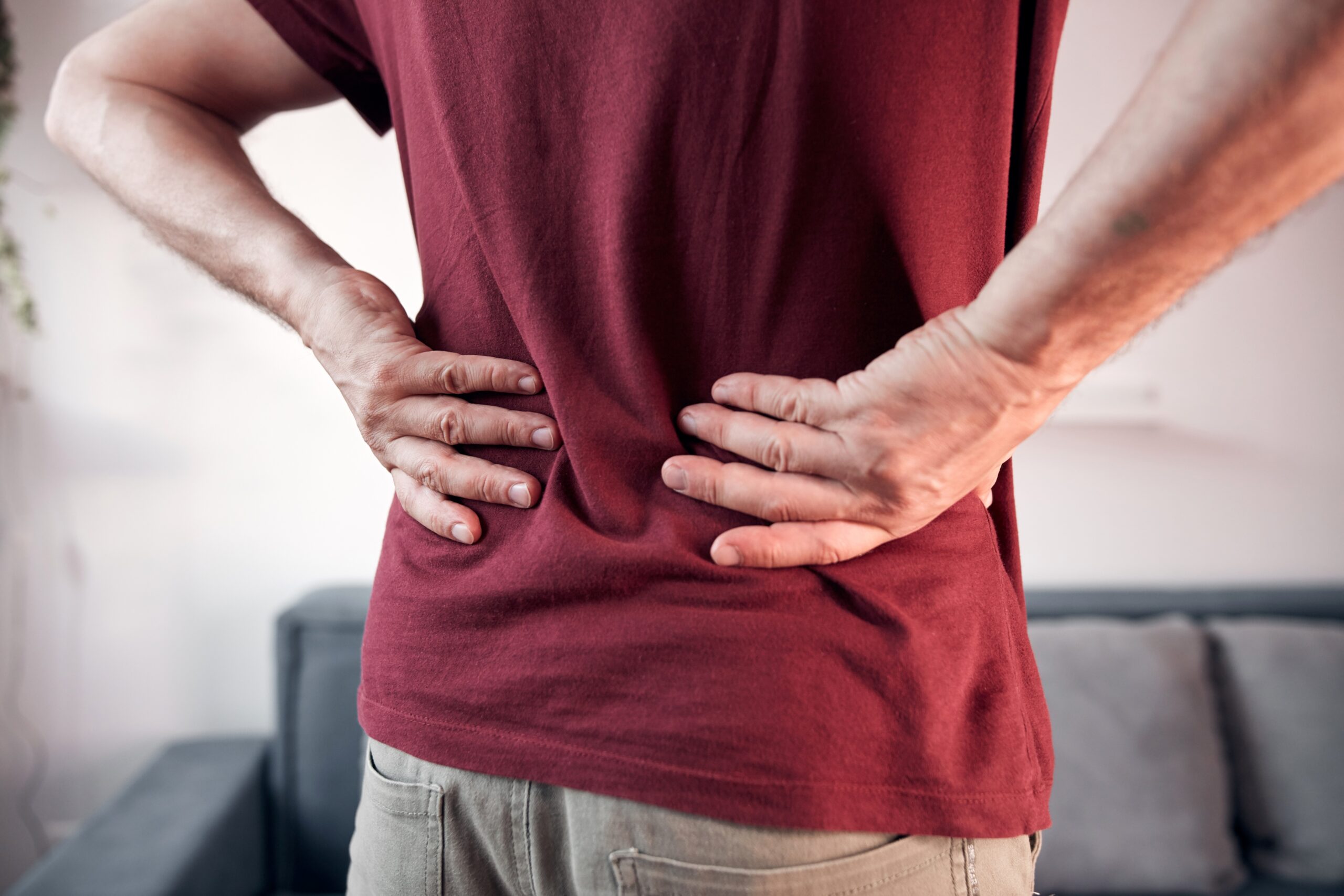 Man,With,Hip,,Back,And,Sciatica,Pain,At,Home.
