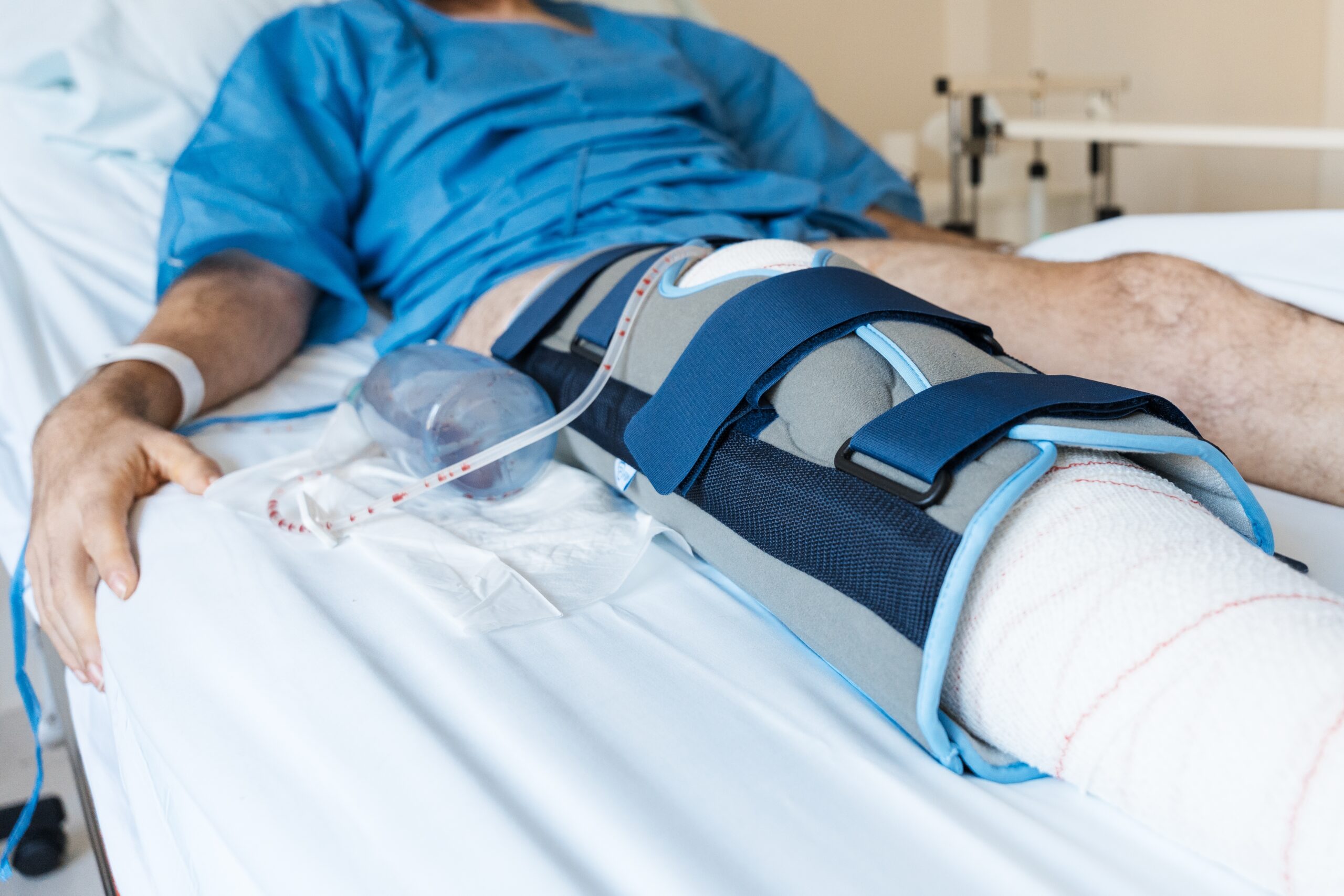 Male,Patient,Lying,In,Hospital,Bed,After,Leg,Surgery,,Wearing
