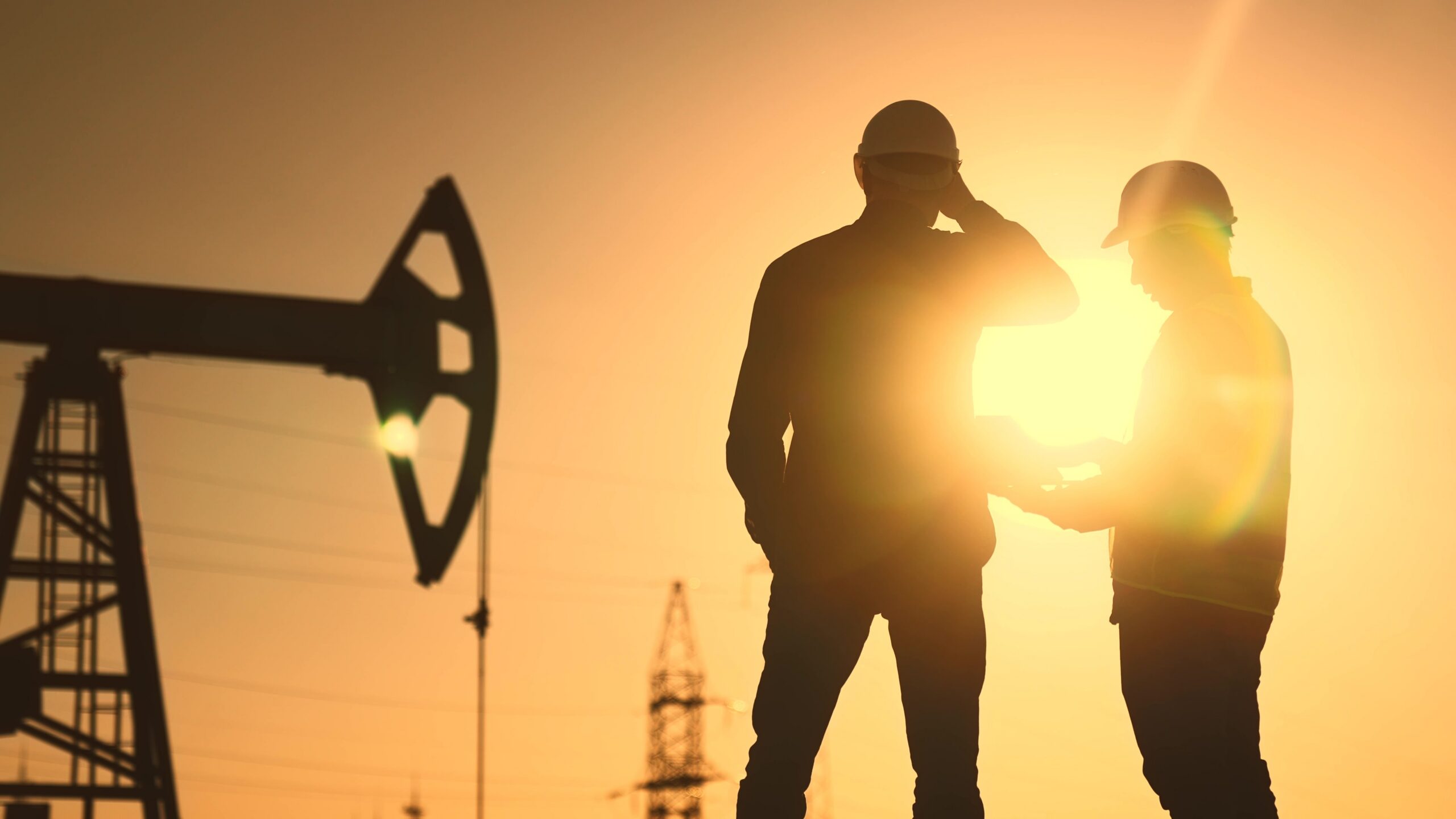 Oil,Production.,Two,Silhouette,Workers,Work,As,A,Team,Next
