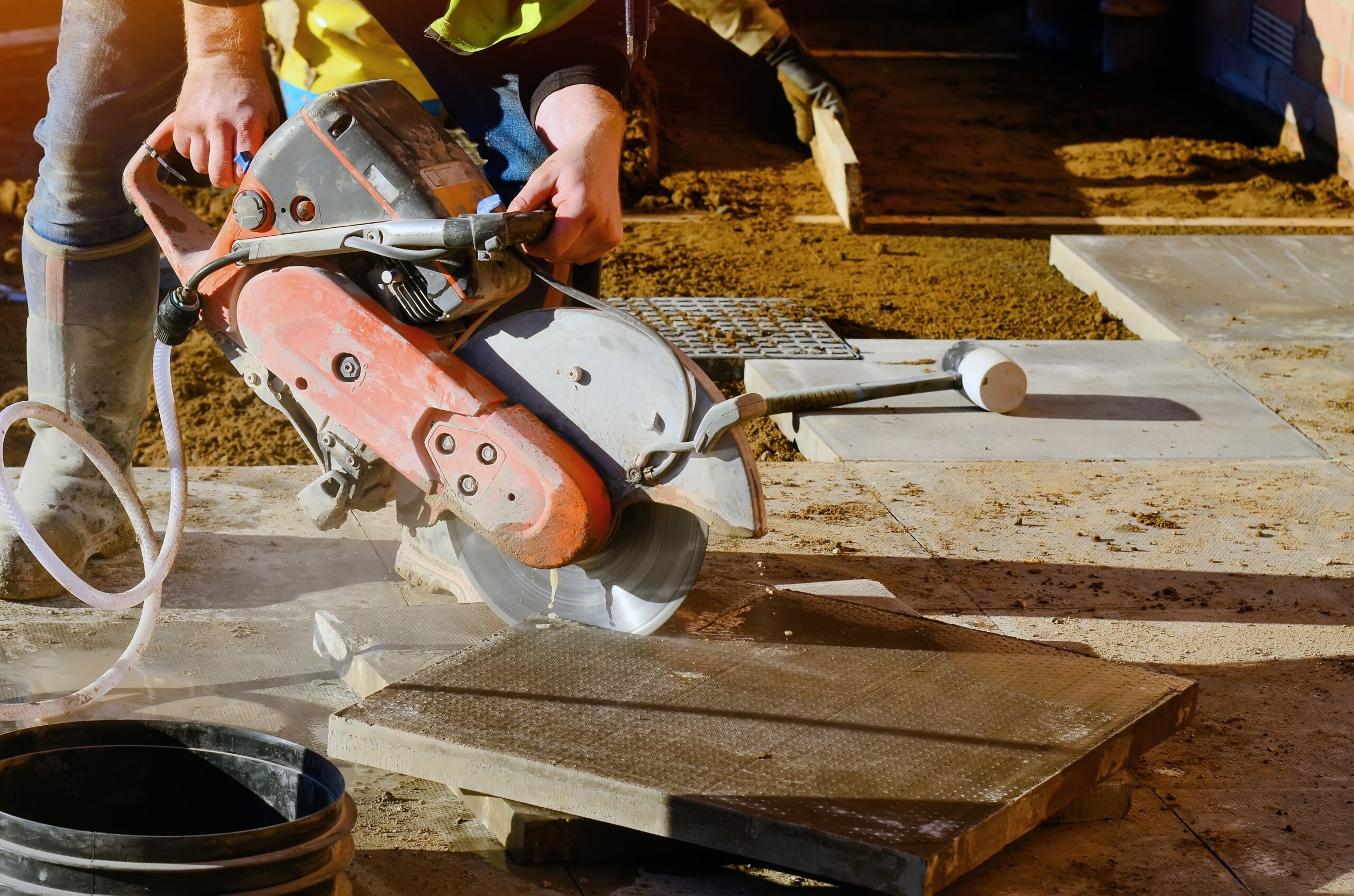 Builder,Cutting,Concrete,Slabs,With,Petrol,Concrete,Saw,And,A