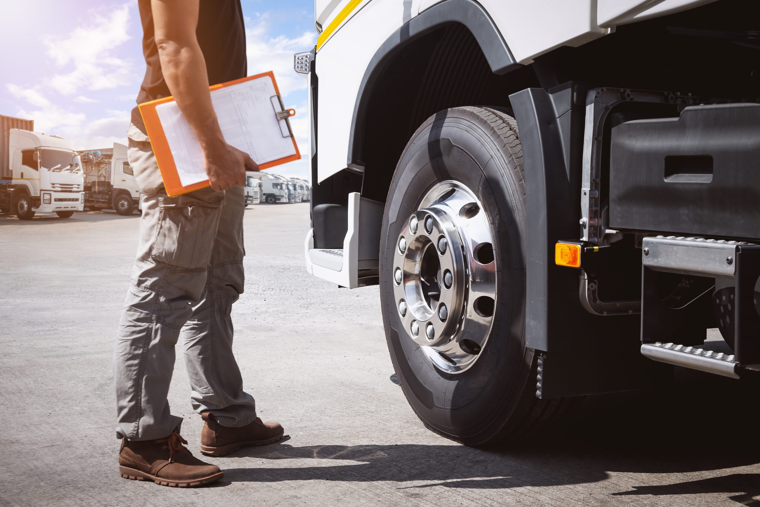 Truck,Drivers,Holding,Clipboard,To,Check,Truck,Tires.,Semi,Truck