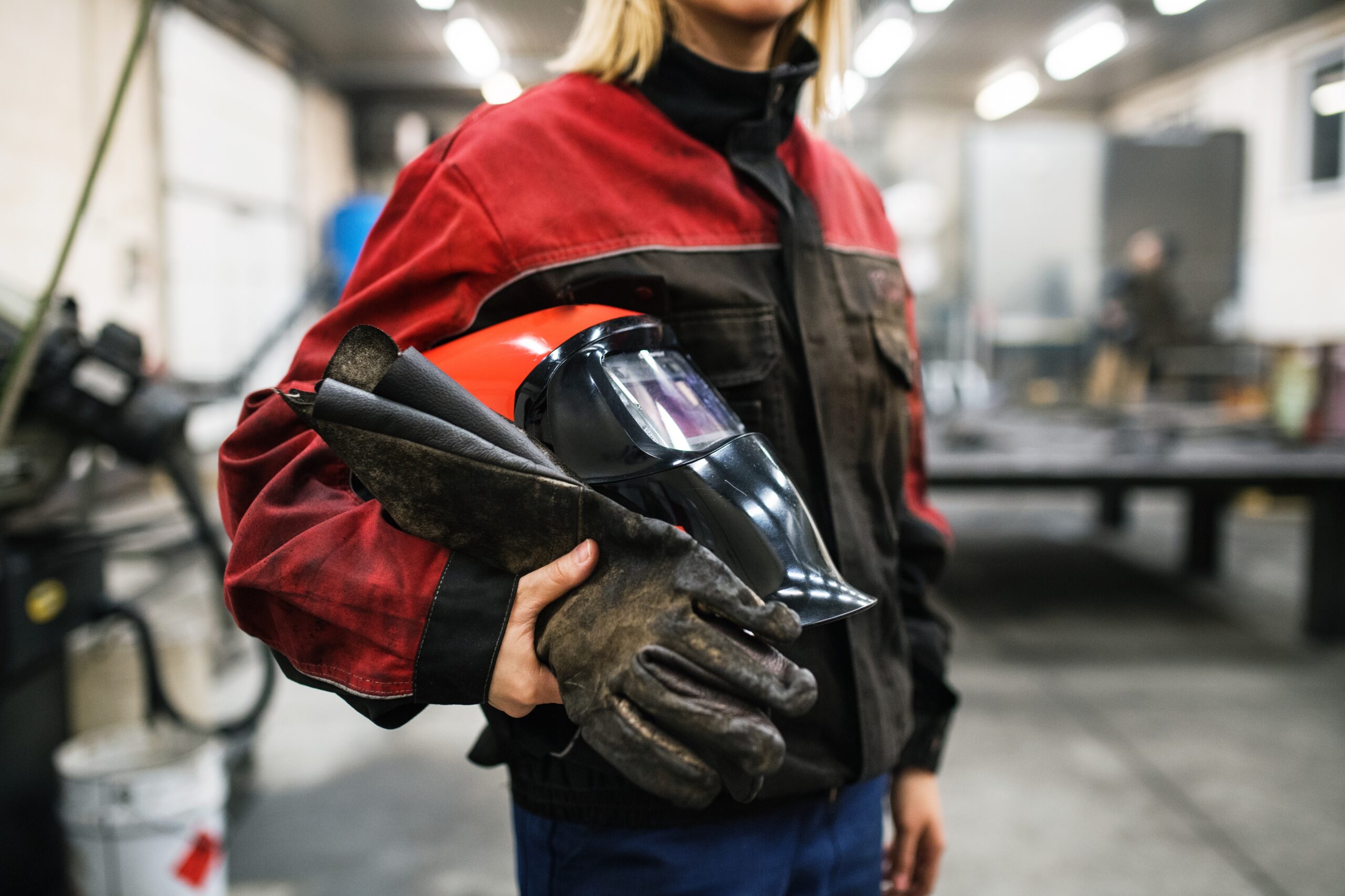 Close,Up,Of,Welding,Mask,In,Hands,Of,Woman,Welder